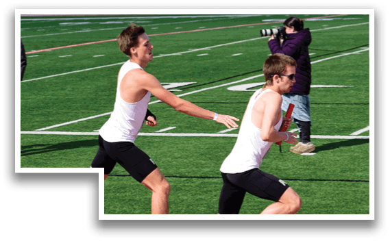 Two men running on a track. Description generated by AI
