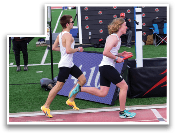 Two men running on a track. Description generated by AI