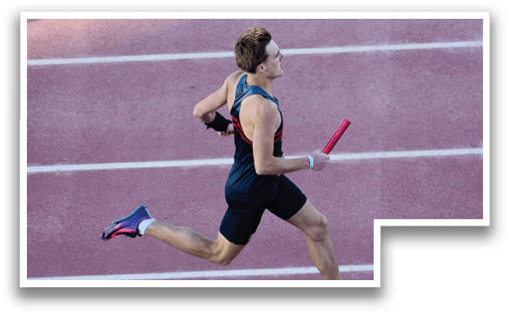 A man running on a track with a red object in his hand. Description generated by AI