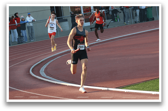 A man running on a track. Description generated by AI