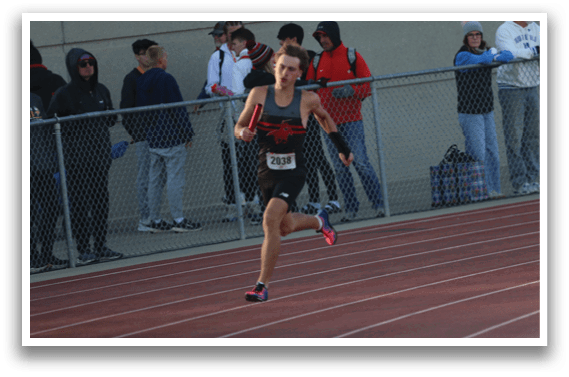 A woman running on a track. Description generated by AI