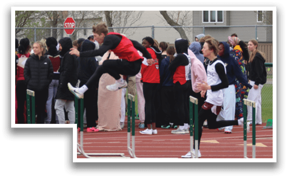 A group of people are standing in front of a track. Description generated by AI