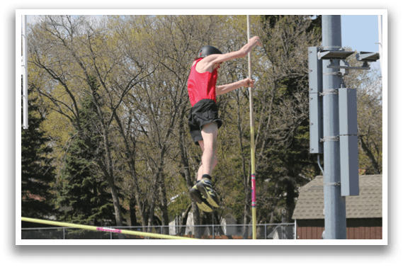 A man is jumping over a bar on a trampoline. Description generated by AI