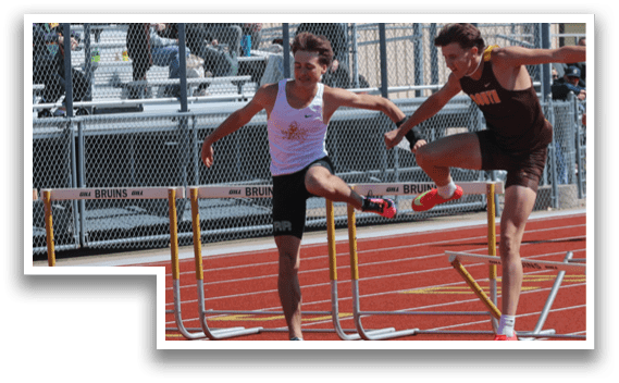 A man running on a track with a group of people watching. Description generated by AI