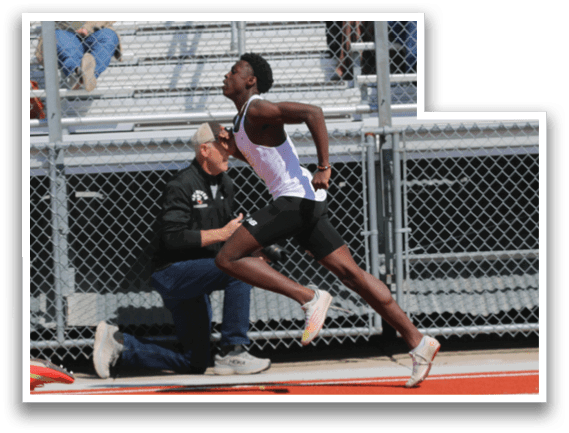 A man running on a track with a crowd watching. Description generated by AI