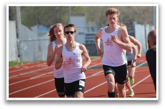 A group of runners on a track. Description generated by AI