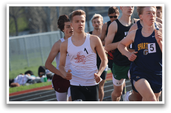 A group of runners on a track. Description generated by AI