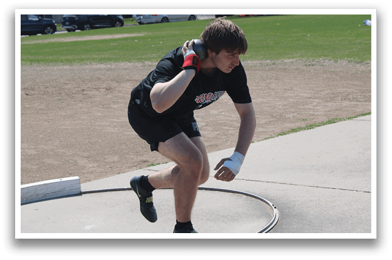 A man wearing a black shirt and red gloves is throwing a frisbee. Description generated by AI