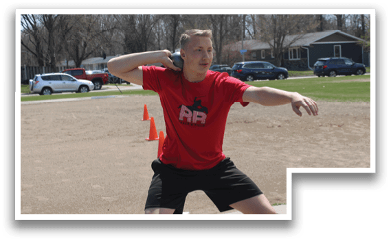 A man in a red shirt is throwing a frisbee. Description generated by AI