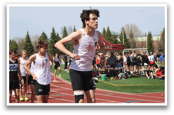 A group of men running on a track. Description generated by AI