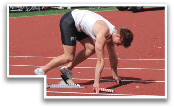 A man is bending over on a track. Description generated by AI