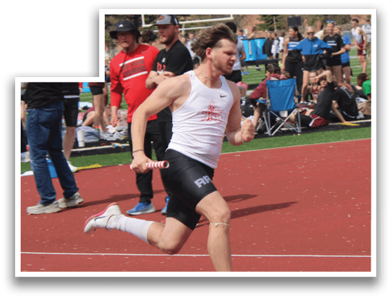 A man running on a track with a green tractor in the background. Description generated by AI