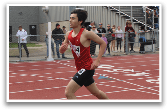A man running on a track. Description generated by AI