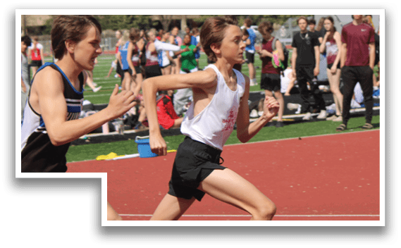 A group of people running on a track. Description generated by AI
