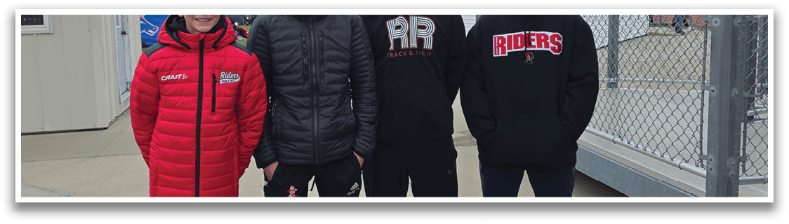 Four young people standing on a sidewalk. Description generated by AI