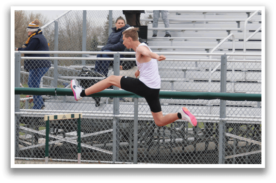 A man is jumping over a hurdle on a track. Description generated by AI
