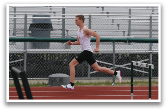 A man running on a track. Description generated by AI