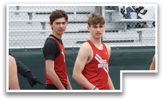 A group of young men wearing red and black shirts and shorts. Description generated by AI