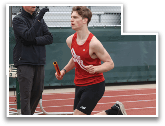 A man wearing a red shirt and black shorts is running on a track. Description generated by AI