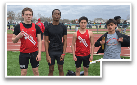 Three young men standing on a grassy field. Description generated by AI