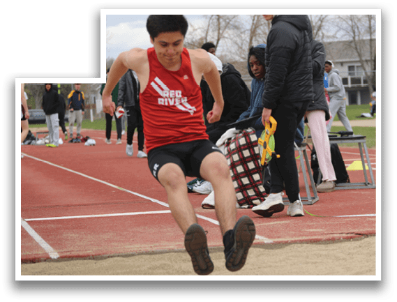 A man wearing a red shirt and black shorts is running on a track. Description generated by AI