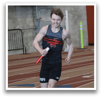 A man running on a track with a red flag in his hand. Description generated by AI