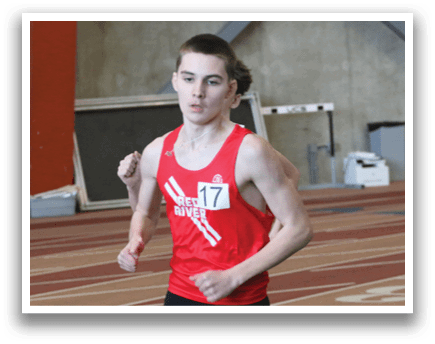 A runner wearing a red shirt and black shorts. Description generated by AI