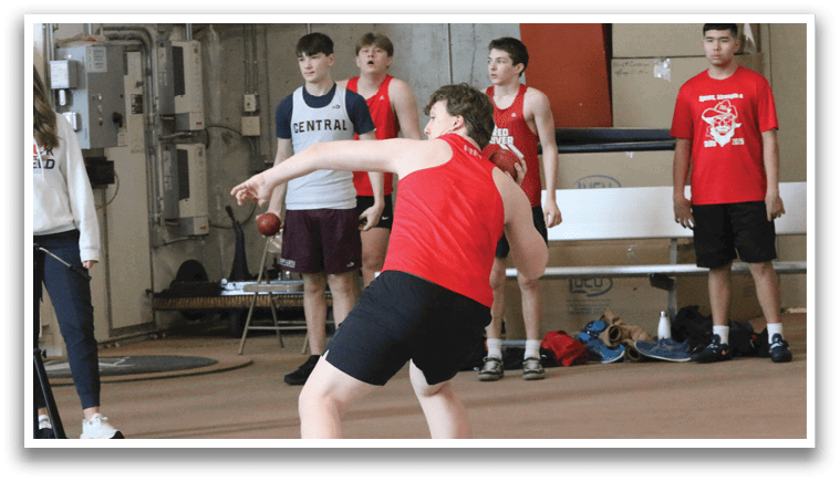 A man in a red shirt is throwing a frisbee. Description generated by AI