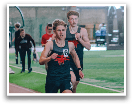 A man running on a track. Description generated by AI
