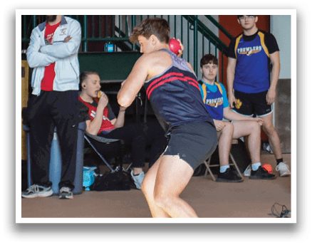 A man is throwing a ball in a gym. Description generated by AI