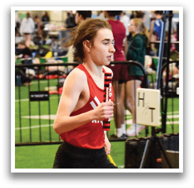 A woman running on a track. Description generated by AI