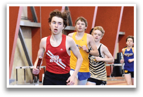 A boy running on a track with a red shirt. Description generated by AI