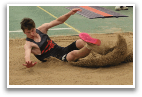 A man is laying on the ground in a sand pit. Description generated by AI