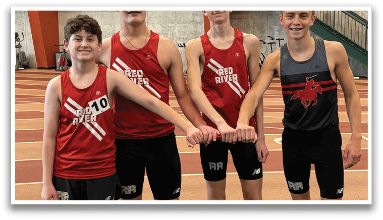 Three boys wearing red shirts and black shorts. Description generated by AI