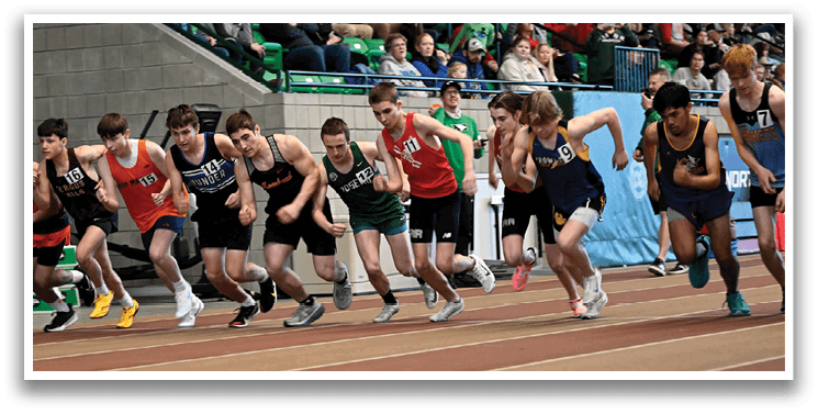 A group of young boys running on a track. Description generated by AI