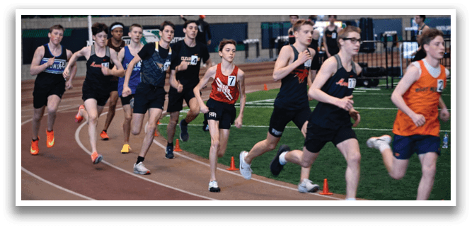 A group of young men running on a track. Description generated by AI