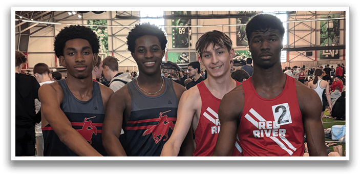 Four young men wearing red and black shirts and shorts. Description generated by AI