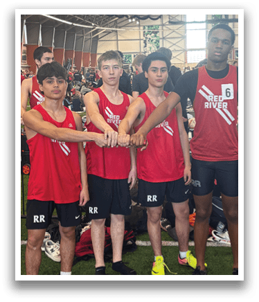 A group of men wearing red shirts and black shorts. Description generated by AI
