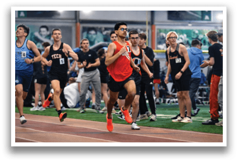A group of people running on a track. Description generated by AI