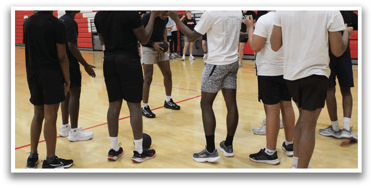 A group of young men in a gym. Description generated by AI