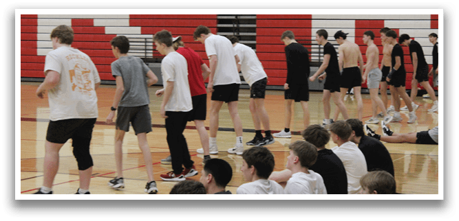 A group of people are standing in a gym. Description generated by AI