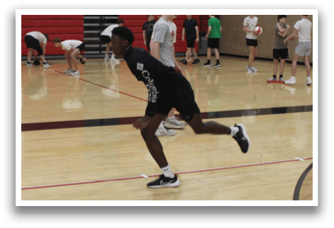 A group of people are playing basketball in a gym. Description generated by AI