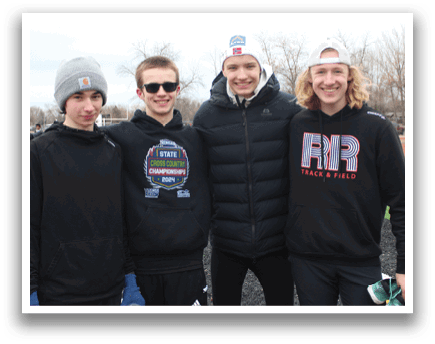 Four young men wearing black hoodies and sunglasses pose for a picture. Description generated by AI
