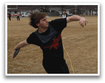 A man is throwing a frisbee in a field. Description generated by AI