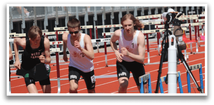 A group of young men running on a track. Description generated by AI