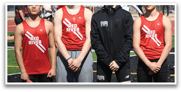 Four young men wearing red and black uniforms. Description generated by AI