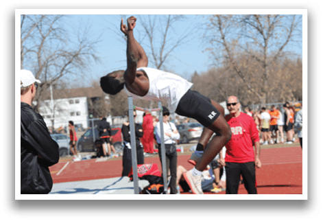 A man is jumping over a barrier. Description generated by AI