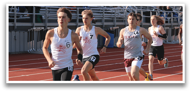 A group of people running on a track. Description generated by AI