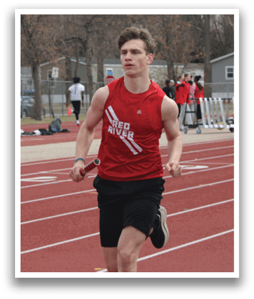 A man running on a track in front of a crowd. Description generated by AI