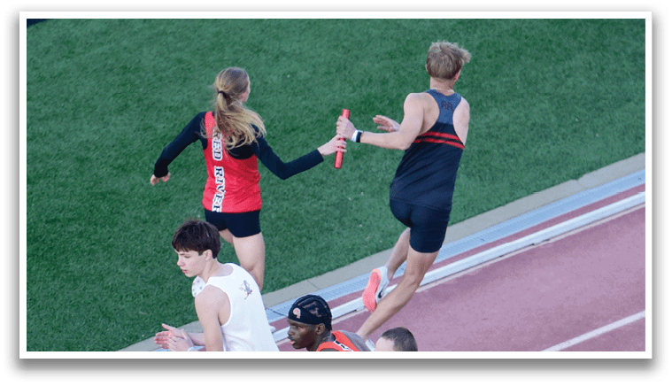 A group of people running on a track. Description generated by AI